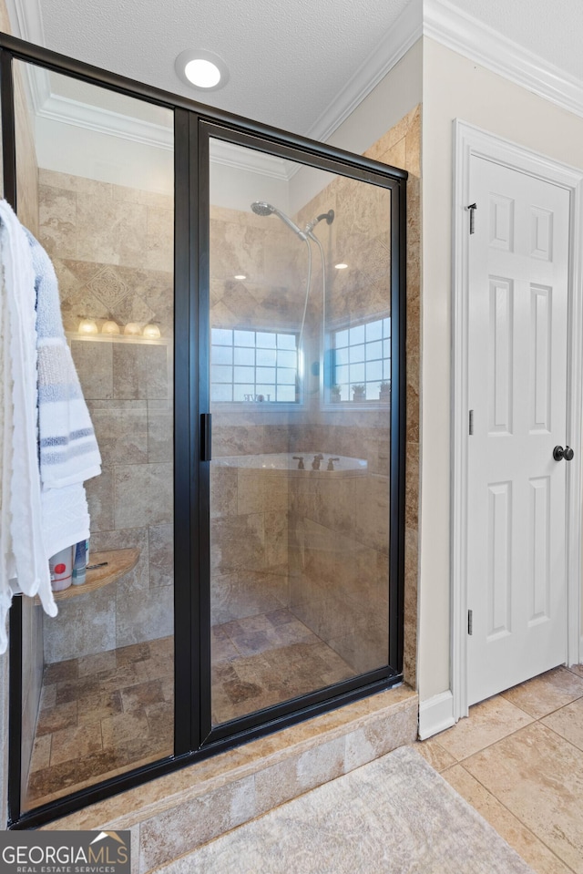 bathroom with crown molding, a shower with shower door, tile patterned flooring, and a textured ceiling