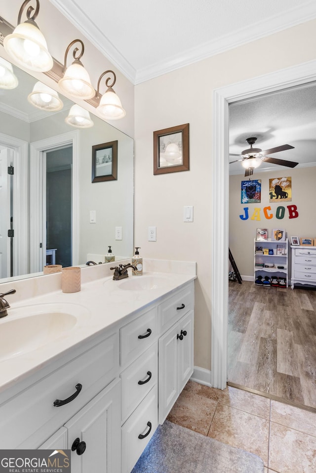 bathroom with crown molding, hardwood / wood-style floors, vanity, and ceiling fan