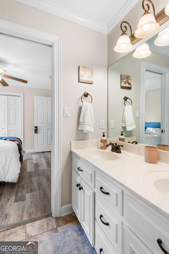 bathroom featuring vanity, hardwood / wood-style floors, crown molding, and ceiling fan