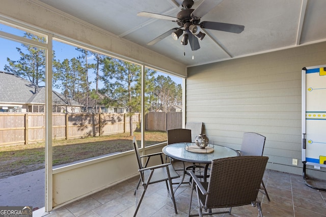 sunroom featuring ceiling fan