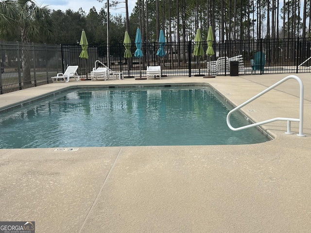 view of swimming pool with a patio