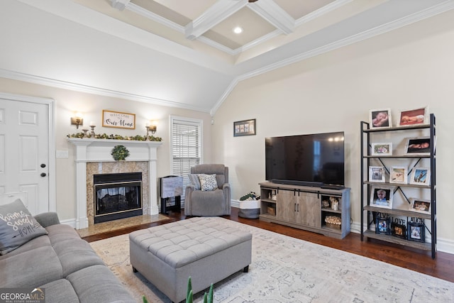 living room with coffered ceiling, vaulted ceiling with beams, ornamental molding, a tiled fireplace, and hardwood / wood-style floors