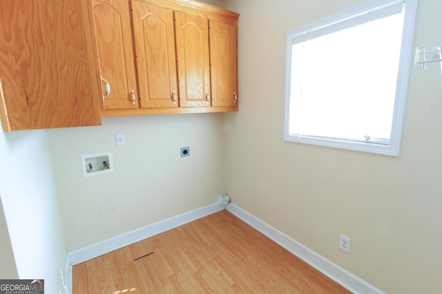 laundry area featuring cabinets, washer hookup, hookup for an electric dryer, and light wood-type flooring