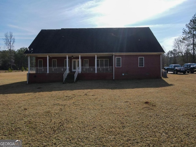 view of front of property with covered porch and a front yard