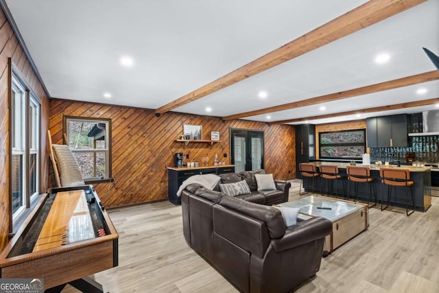 living area with light wood finished floors, indoor wet bar, beam ceiling, and recessed lighting