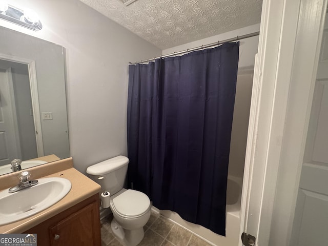 full bathroom with shower / tub combo with curtain, vanity, a textured ceiling, tile patterned floors, and toilet