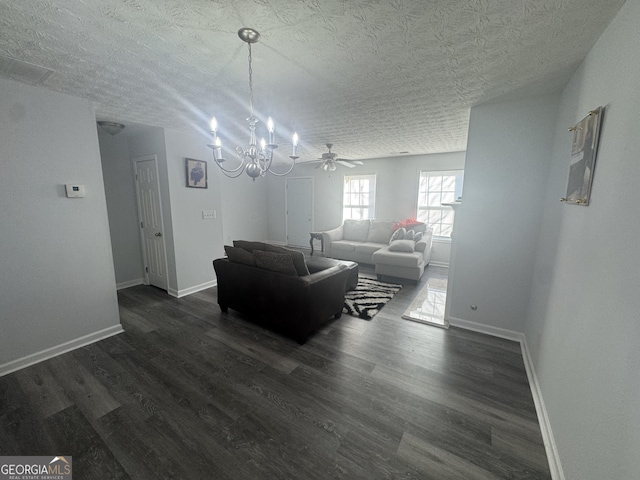 living room with dark hardwood / wood-style flooring, a chandelier, and a textured ceiling