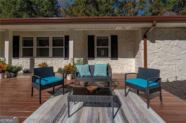 wooden terrace featuring an outdoor hangout area