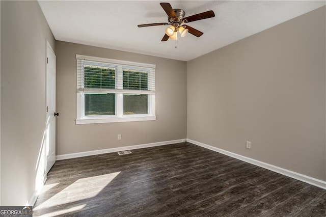 spare room featuring dark hardwood / wood-style floors and ceiling fan