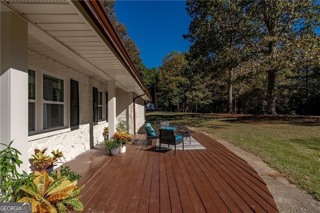 wooden terrace featuring a lawn