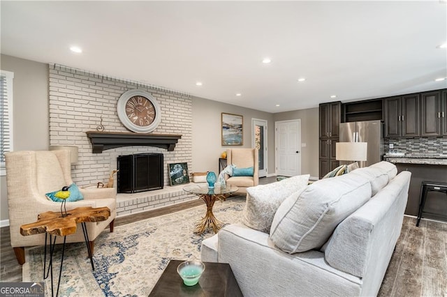 living room featuring a fireplace and dark hardwood / wood-style flooring