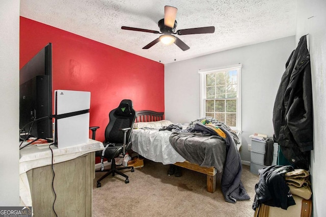 carpeted bedroom with ceiling fan and a textured ceiling