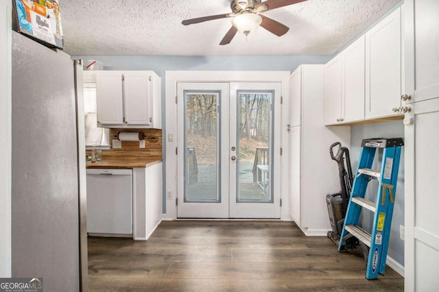 doorway to outside with ceiling fan, dark hardwood / wood-style floors, french doors, and a textured ceiling