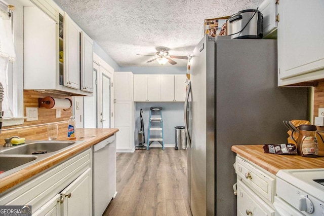 kitchen with white cabinetry, a textured ceiling, white dishwasher, ceiling fan, and light hardwood / wood-style floors