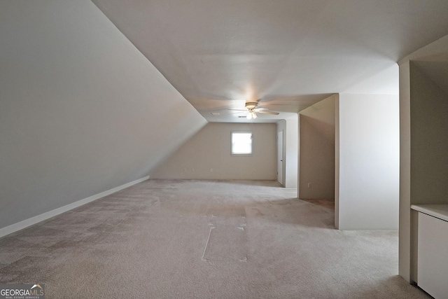 bonus room with ceiling fan, vaulted ceiling, and light carpet