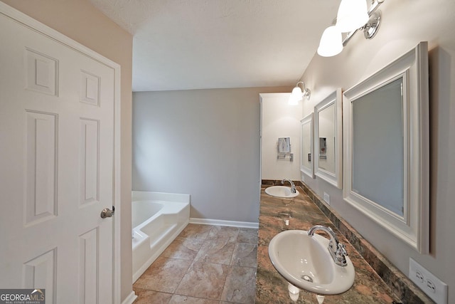 bathroom with sink and a washtub