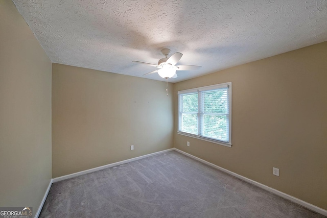 unfurnished room with carpet flooring, a textured ceiling, and ceiling fan