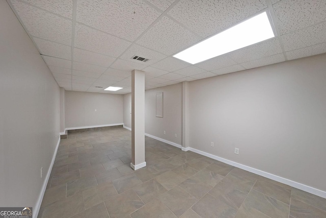 basement featuring a paneled ceiling