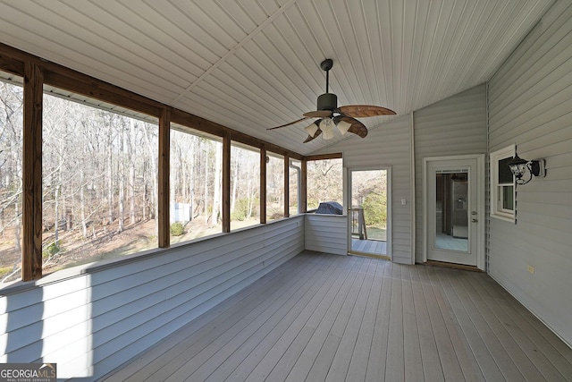 unfurnished sunroom with ceiling fan and lofted ceiling