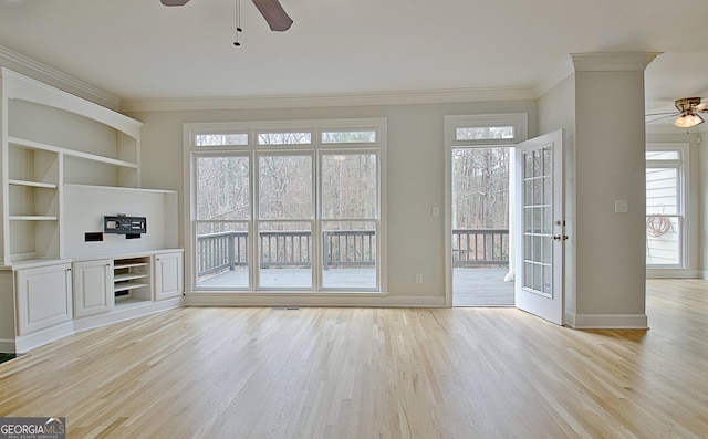 unfurnished living room with ceiling fan, ornamental molding, and light hardwood / wood-style floors