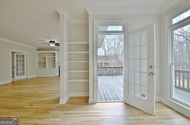 doorway with ceiling fan, ornamental molding, and light hardwood / wood-style flooring