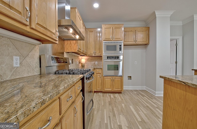 kitchen featuring stainless steel appliances, crown molding, light stone countertops, light wood-type flooring, and wall chimney exhaust hood