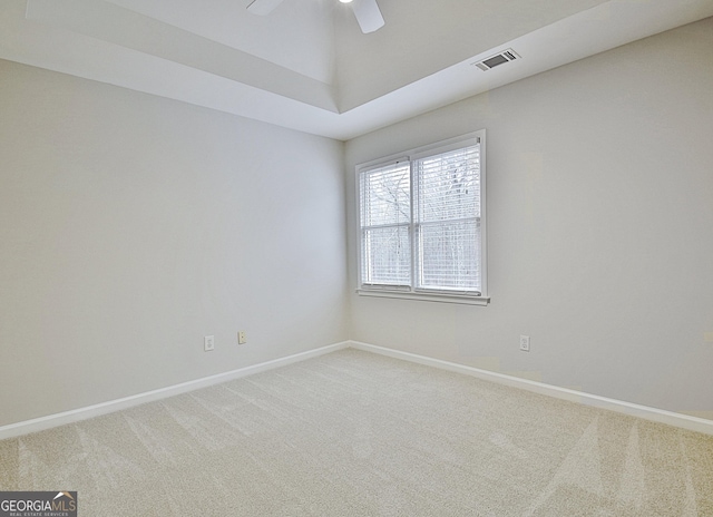 carpeted spare room with ceiling fan