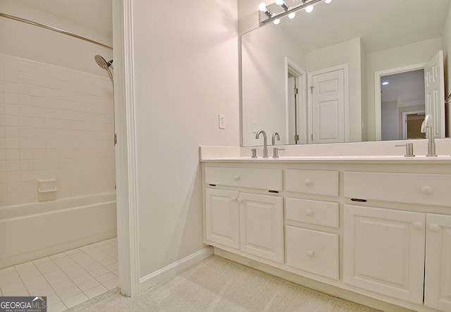 bathroom with vanity, tiled shower / bath combo, and tile patterned flooring