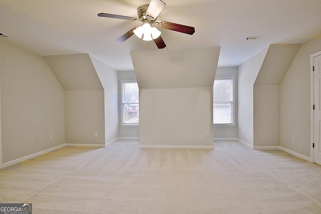 bonus room featuring lofted ceiling, light carpet, and ceiling fan