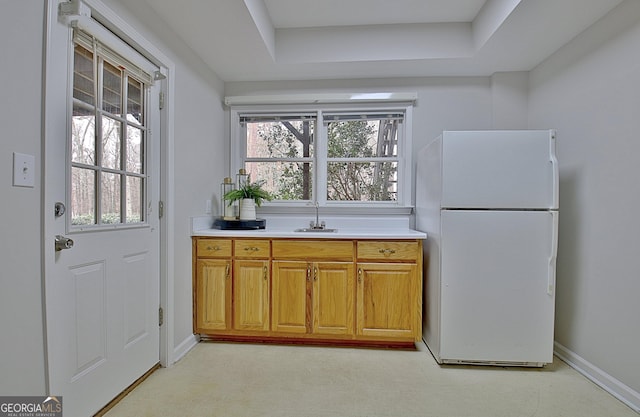 kitchen with sink and white fridge