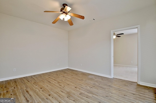 spare room with ceiling fan and light hardwood / wood-style floors