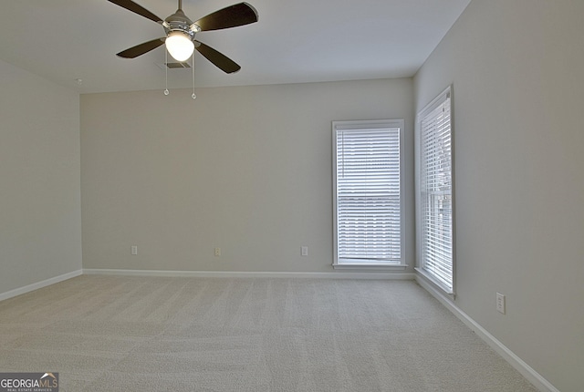 carpeted spare room with ceiling fan