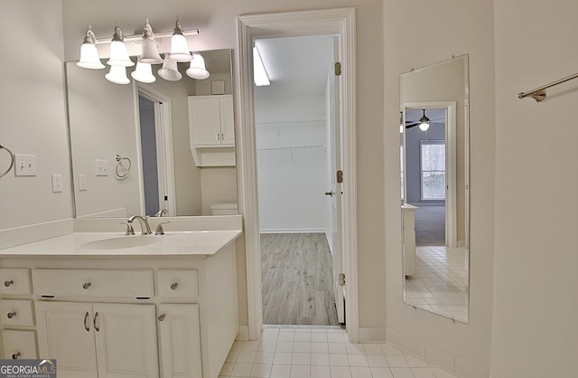 bathroom with tile patterned flooring, vanity, and toilet