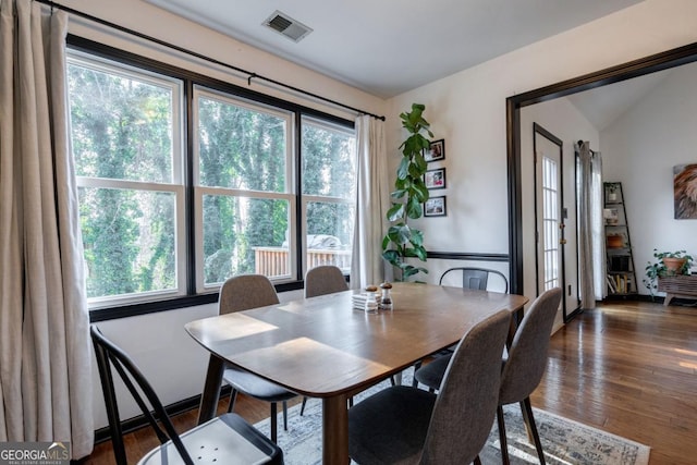 dining room featuring plenty of natural light and dark hardwood / wood-style flooring