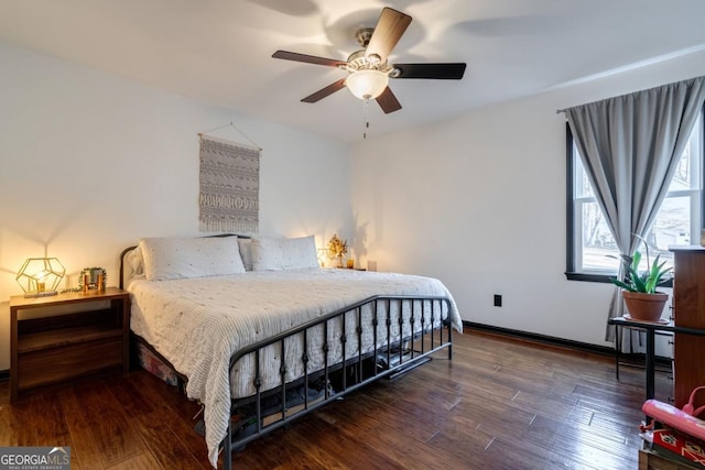 bedroom with ceiling fan and dark hardwood / wood-style floors