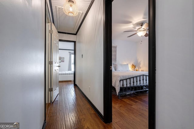 corridor featuring crown molding and hardwood / wood-style flooring