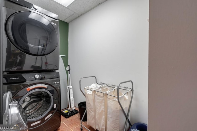 washroom with light tile patterned flooring and stacked washer / drying machine