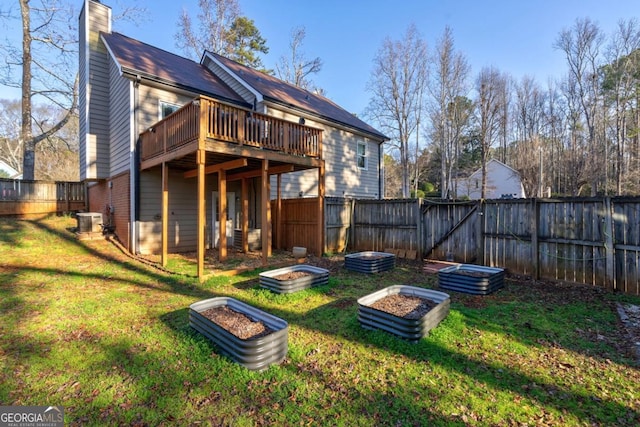 back of house with cooling unit, a yard, and a deck