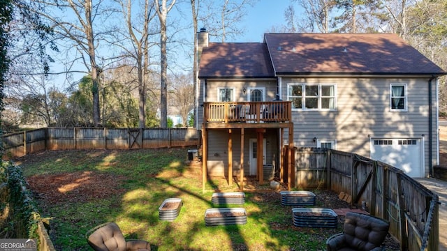 back of property with a garage, cooling unit, a deck, and a lawn