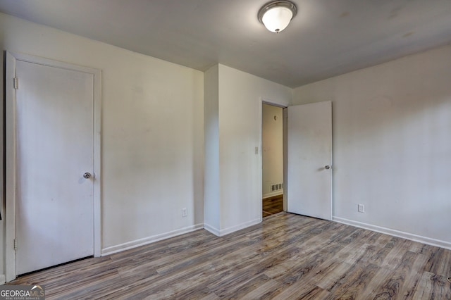 unfurnished bedroom with light wood-type flooring