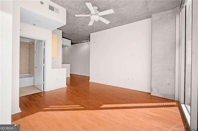 unfurnished room with hardwood / wood-style flooring and ceiling fan