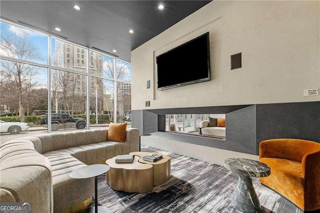 living room featuring expansive windows and a fireplace