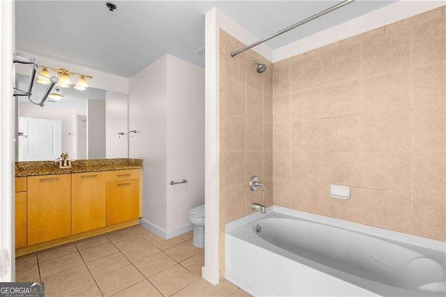 full bathroom with vanity, tiled shower / bath, tile patterned floors, and toilet