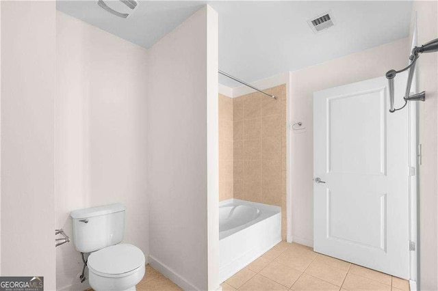 bathroom featuring toilet, shower / bath combination, and tile patterned flooring