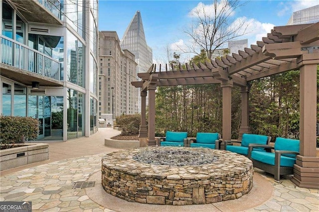 view of patio / terrace with a pergola and an outdoor living space with a fire pit