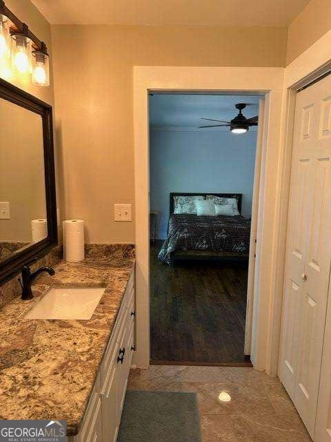 bathroom with ceiling fan and vanity