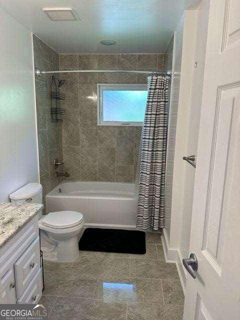 full bathroom featuring vanity, toilet, and shower / bathtub combination with curtain