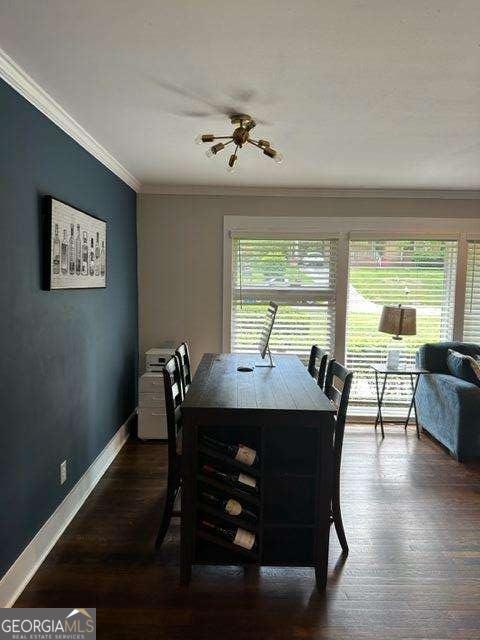 dining area featuring crown molding and dark hardwood / wood-style floors