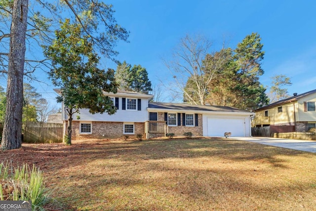 split level home featuring a garage and a front yard