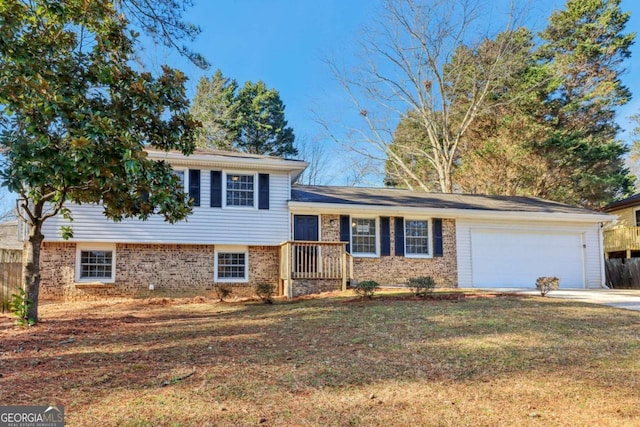 tri-level home featuring a garage and a front lawn